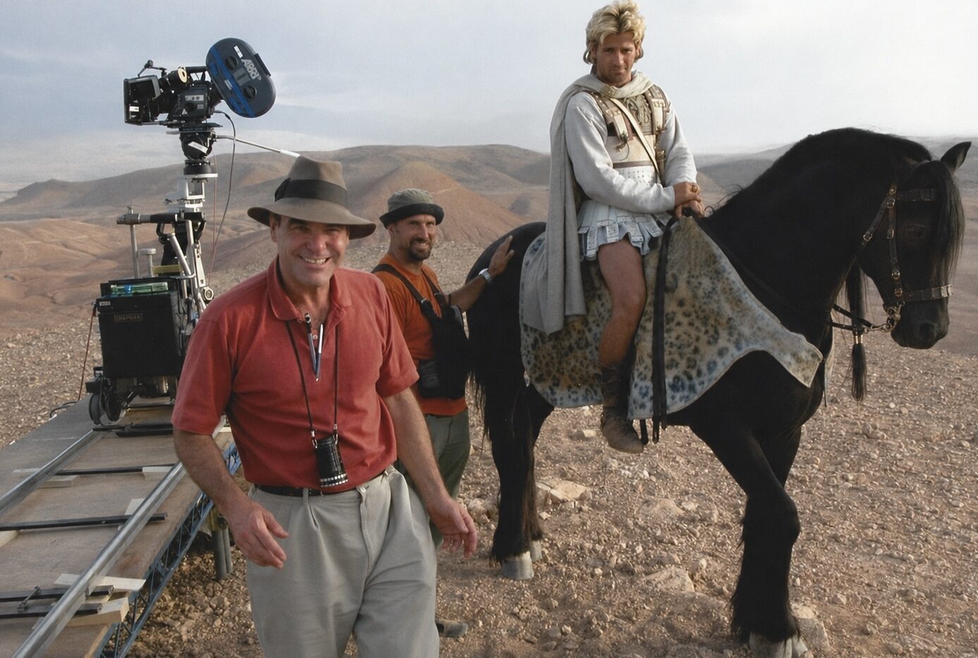 Peter Pedrero beside the camera during a horseback action production — Alexander