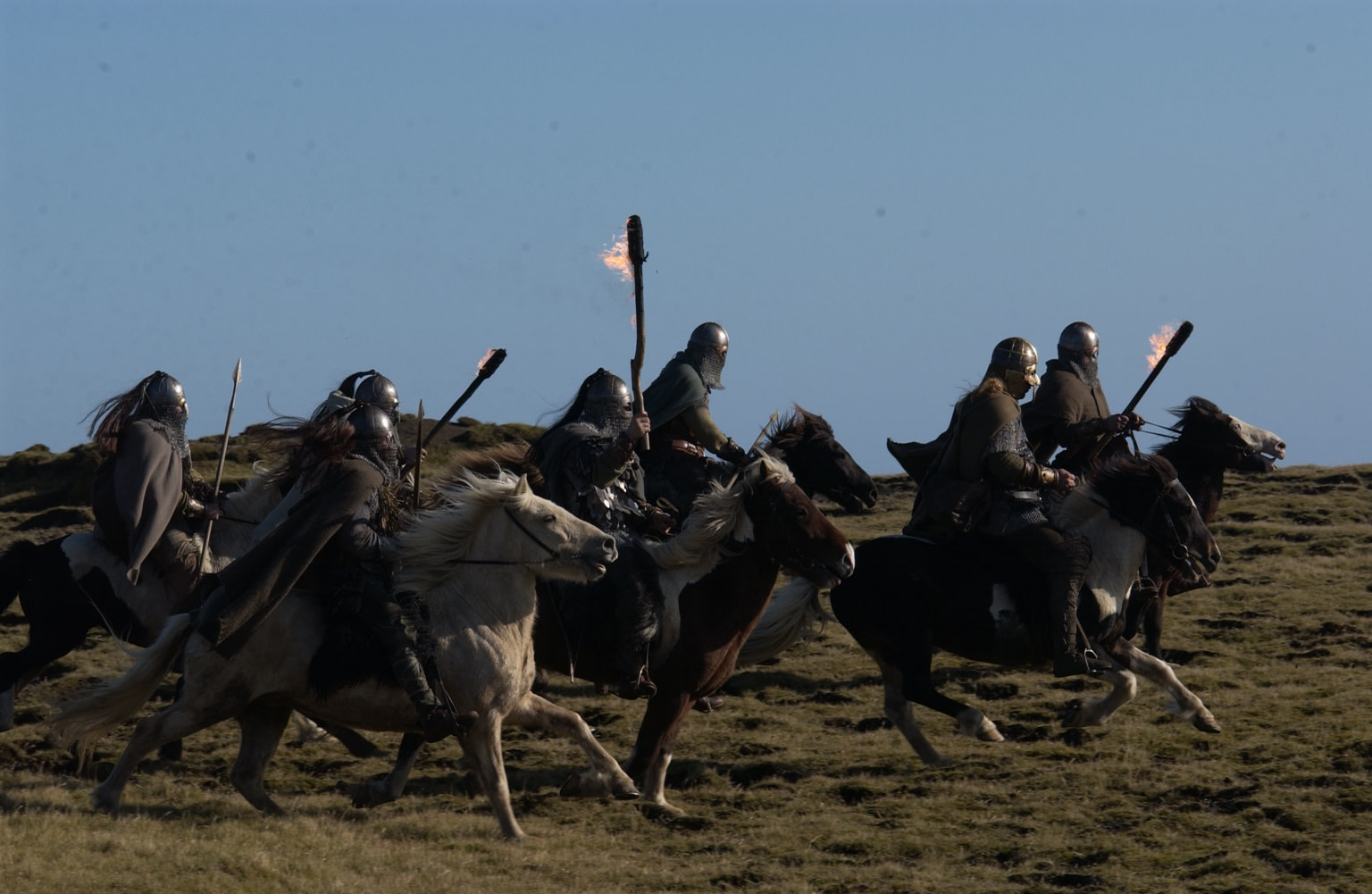 Mounted warriors riding with flaming torches — Beowulf & Grendel