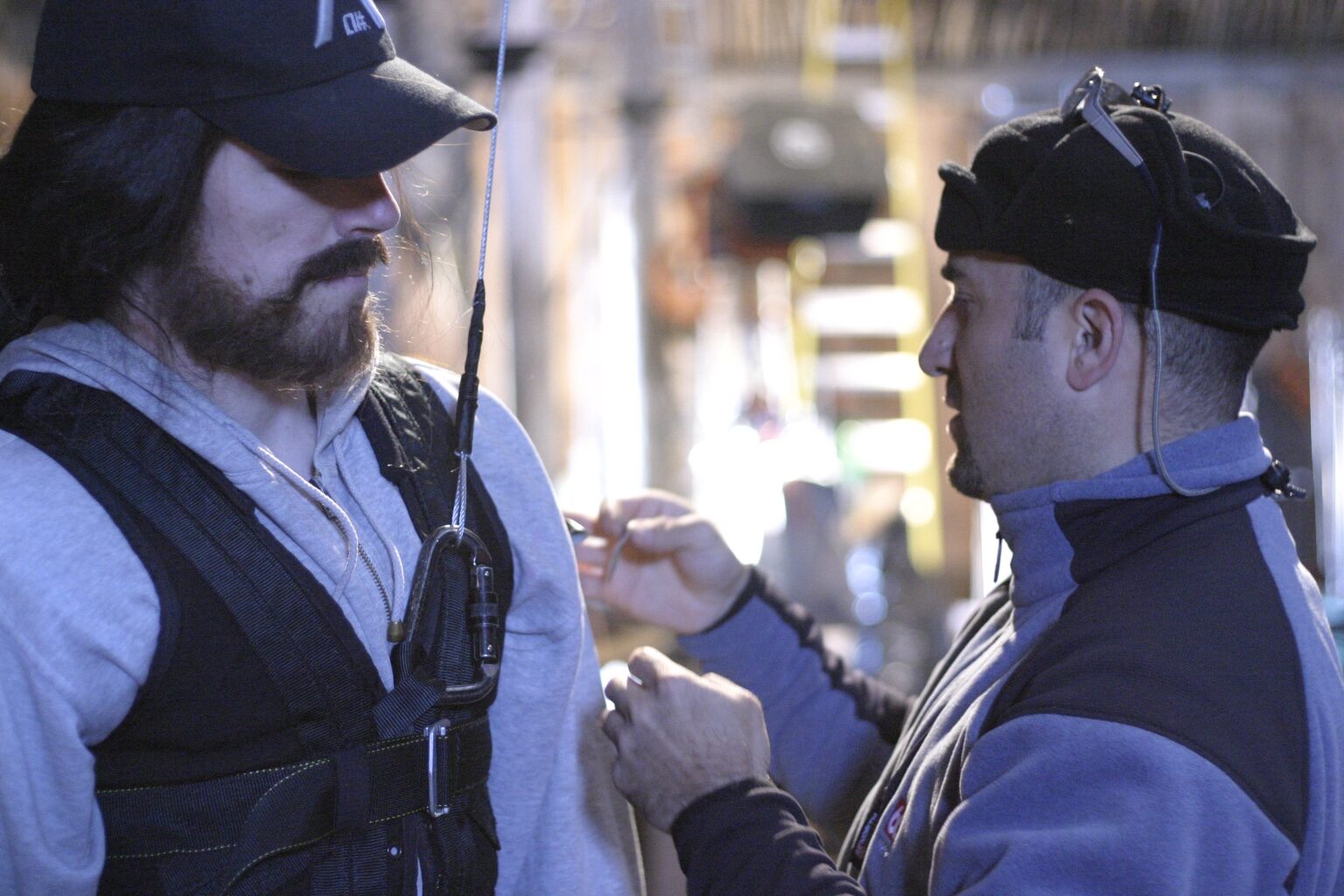 Peter Pedrero in conversation with a performer on set — Beowulf & Grendel