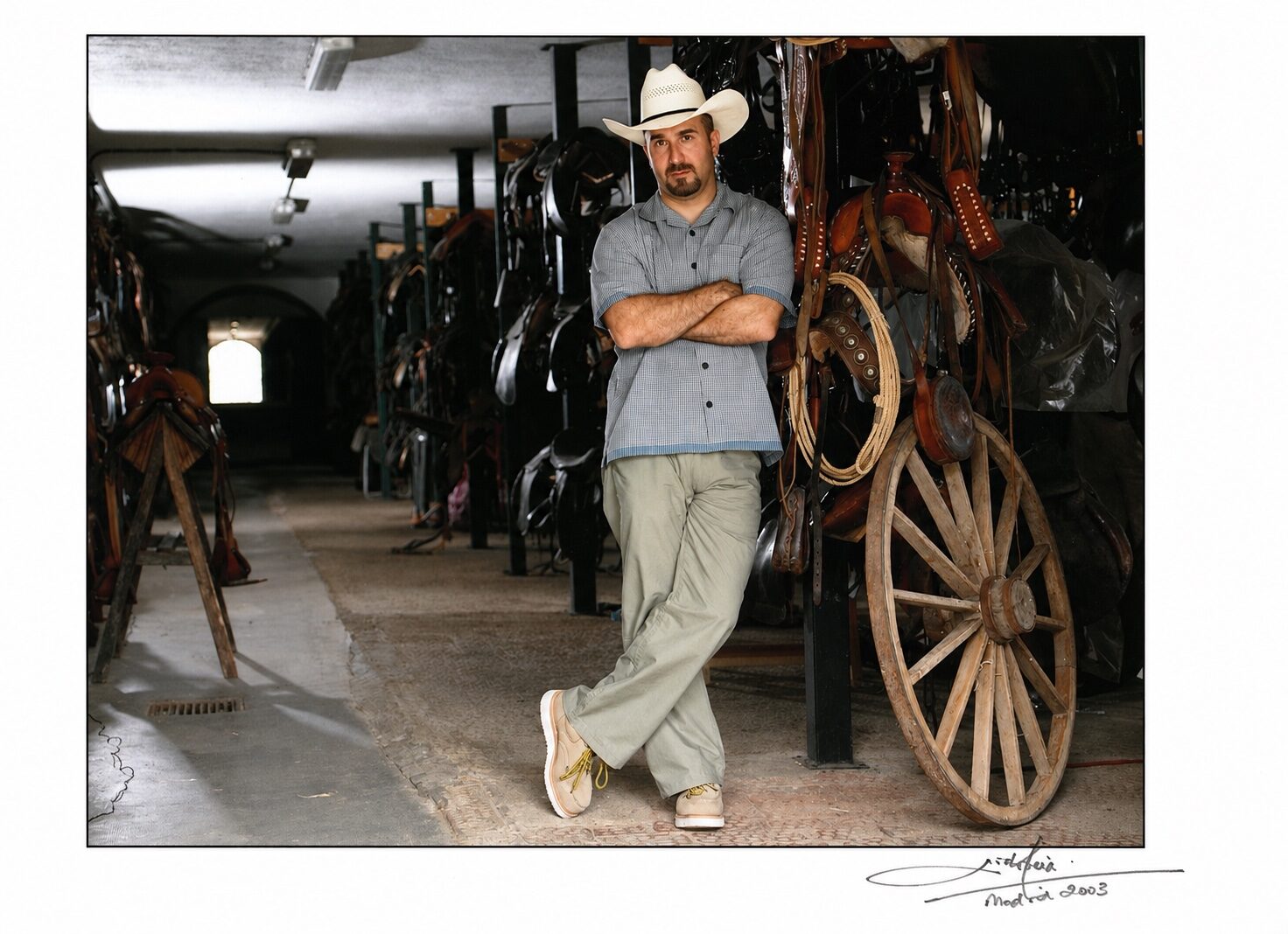 Peter Pedrero in Western costume beside production props — Alexander