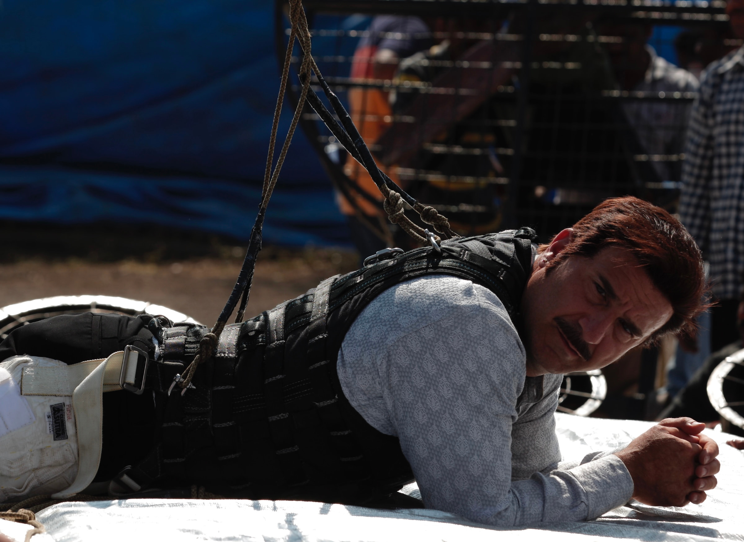 Costume performer beneath stunt rigging