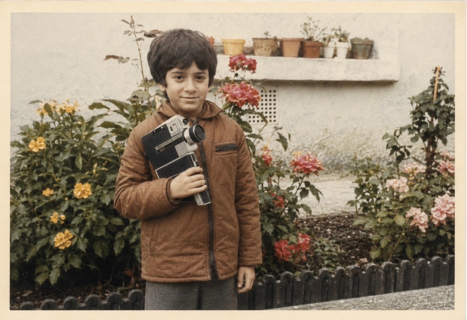 Peter Pedrero as a child holding a Super 8 camera
